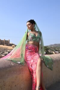 Mehendi Sangeet Special. Features a vibrant green lehenga and a pink top adorned with intricate floral designs.